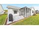 Private backyard patio with screened enclosure and grill at 1904 De Hoyos Pl, The Villages, FL 32159