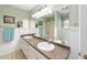 Double vanity bathroom with large mirror and shower at 1904 De Hoyos Pl, The Villages, FL 32159