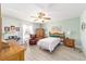 Bedroom with wooden furniture and a ceiling fan at 1904 De Hoyos Pl, The Villages, FL 32159