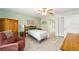 Bedroom with twin bed, recliner, and bathroom access at 1904 De Hoyos Pl, The Villages, FL 32159