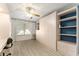 Bright bedroom with built-in shelving and cabinets, offering ample storage space and natural light at 1904 De Hoyos Pl, The Villages, FL 32159