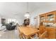 Open-concept dining area boasts a wooden table and hutch, seamlessly connecting to the living spaces at 1904 De Hoyos Pl, The Villages, FL 32159
