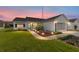 Well-maintained house with a landscaped lawn and a two-car garage at 1904 De Hoyos Pl, The Villages, FL 32159