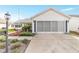 House exterior showcasing a driveway and well-maintained landscaping at 1904 De Hoyos Pl, The Villages, FL 32159