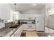 Bright kitchen with white cabinets, granite countertops, modern appliances, and breakfast bar seating at 1904 De Hoyos Pl, The Villages, FL 32159