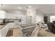 Open kitchen features a breakfast bar with seating, white cabinets, and granite countertops at 1904 De Hoyos Pl, The Villages, FL 32159