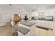 Open kitchen features granite countertops, white cabinetry, breakfast bar and seamlessly connects to the dining area at 1904 De Hoyos Pl, The Villages, FL 32159