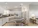 Bright kitchen featuring white cabinetry, granite countertops, island with bar seating, and modern appliances at 1904 De Hoyos Pl, The Villages, FL 32159