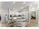 Well-lit kitchen featuring granite countertops and white appliances, seamlessly connects to the cozy bedroom space at 1904 De Hoyos Pl, The Villages, FL 32159