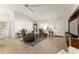 Airy living room with vaulted ceilings, a comfortable seating arrangement, and stylish light fixtures at 1904 De Hoyos Pl, The Villages, FL 32159