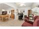 Spacious living room featuring wood-look floors, classic furniture, and natural light at 1904 De Hoyos Pl, The Villages, FL 32159