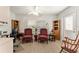 Cozy living room featuring classic furniture, wood-look floors, and bright windows at 1904 De Hoyos Pl, The Villages, FL 32159