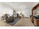 Bright living room boasts vaulted ceilings, a front door and updated wood-look flooring at 1904 De Hoyos Pl, The Villages, FL 32159