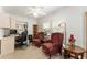 Inviting home office featuring wood-look floors, bright lighting, classic furniture, and ample desk space at 1904 De Hoyos Pl, The Villages, FL 32159