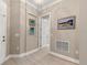 Light and airy hallway with neutral walls and light wood flooring at 2018 Wallingford Loop, Mount Dora, FL 32757