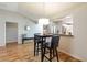 Dining area featuring wood floors, a view to the kitchen, and seating for two at 2407 Saluda St, The Villages, FL 32162