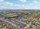Aerial view of community, showcasing homes and surrounding landscape at 2486 Five Forks Trl, The Villages, FL 32162