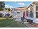 Home features a screened porch and a red door leading to it at 2486 Five Forks Trl, The Villages, FL 32162