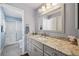 Bright bathroom with granite countertop, updated vanity, and shower at 2486 Five Forks Trl, The Villages, FL 32162