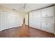 Guest bedroom with built-in cabinets and hardwood floors at 2486 Five Forks Trl, The Villages, FL 32162
