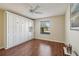 Bedroom with built-in wall unit and hardwood flooring at 2486 Five Forks Trl, The Villages, FL 32162