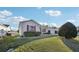 Tan one-story house with red shutters and nicely manicured lawn at 2486 Five Forks Trl, The Villages, FL 32162