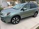 Green Subaru Forester with roof rack, parked in a driveway at 2486 Five Forks Trl, The Villages, FL 32162