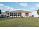Ranch-style home with a screened porch and a large backyard at 2486 Five Forks Trl, The Villages, FL 32162