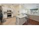 Bright kitchen, stainless steel appliances, and an island at 2486 Five Forks Trl, The Villages, FL 32162
