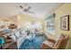 Living room with hardwood floors, neutral-toned furniture, and a ceiling fan at 2486 Five Forks Trl, The Villages, FL 32162