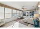 Relaxing sunroom with tiled floors and comfy seating at 2486 Five Forks Trl, The Villages, FL 32162
