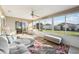 Bright sunroom featuring a sectional sofa and large windows at 2486 Five Forks Trl, The Villages, FL 32162