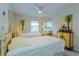 Guest bedroom with twin beds and cheerful decor at 26637 Bermuda Dr, Tavares, FL 32778