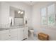 Bright bathroom with a single vanity and patterned floor at 2746 Se 19Th Ct, Ocala, FL 34471