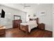 Bedroom with hardwood floors, wood furniture, and plantation shutters at 2746 Se 19Th Ct, Ocala, FL 34471