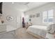 Bedroom with a queen bed, desk, and window with shutters at 2746 Se 19Th Ct, Ocala, FL 34471