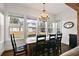 Sunlit dining area with farmhouse table and chandelier at 2746 Se 19Th Ct, Ocala, FL 34471