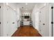 Bright hallway with built-in shelving and hardwood floors at 2746 Se 19Th Ct, Ocala, FL 34471