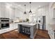Spacious kitchen with white cabinets, stainless steel appliances, and a large island at 2746 Se 19Th Ct, Ocala, FL 34471
