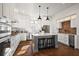 Spacious kitchen with white cabinets, stainless steel appliances, and a large island at 2746 Se 19Th Ct, Ocala, FL 34471