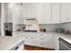 Modern kitchen with white cabinets, gas cooktop and marble countertops at 2746 Se 19Th Ct, Ocala, FL 34471