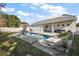 Inviting backyard pool with lounge chairs and covered patio at 2746 Se 19Th Ct, Ocala, FL 34471