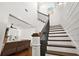 Elegant staircase with dark wood and metal accents at 2746 Se 19Th Ct, Ocala, FL 34471