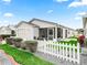 Charming home with a screened porch, white picket fence, and well-manicured lawn at 2806 Salamanca St, The Villages, FL 32162