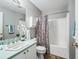 Clean bathroom with a tub shower, updated vanity, and stylish decor at 2806 Salamanca St, The Villages, FL 32162