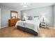 Bright bedroom with a king-size bed and wood flooring at 2806 Salamanca St, The Villages, FL 32162