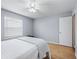 Light and airy bedroom with a queen-size bed and wood floors at 2806 Salamanca St, The Villages, FL 32162