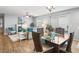 Open concept dining room with a view of the living room and kitchen at 2806 Salamanca St, The Villages, FL 32162