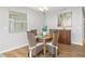 A charming dining area with a rustic wooden table and wicker chairs at 2806 Salamanca St, The Villages, FL 32162