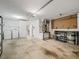 Spacious garage with workshop area and storage shelves at 2806 Salamanca St, The Villages, FL 32162